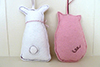 handmade felt rabbit and pig decoration from behind showing tail detailing